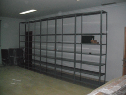 M&oacute;dulo de cinco cuerpos de estanter&iacute;a anclados a la pared entrando a la derecha. Estos cuerpos hoy sostienen las unidades de instalaci&oacute;n de la Hemeroteca Auxiliar Especializada